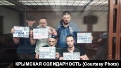 Фигуранты второго симферопольского дела «Хизб ут-Тахрир» с плакатами