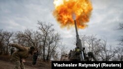 Українська військовослужбовець разом з іншими побратимами-артилеристами веде вогонь з САУ 2С7 «Піон» по позиціях російської армії, Херсонська область, 9 листопада 2022 року
