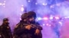 TOPSHOT - Law enforcement take positions on the streets surrounding the federal building during a protest following federal immigration operations in Los Angeles, California, on June 8, 2025.